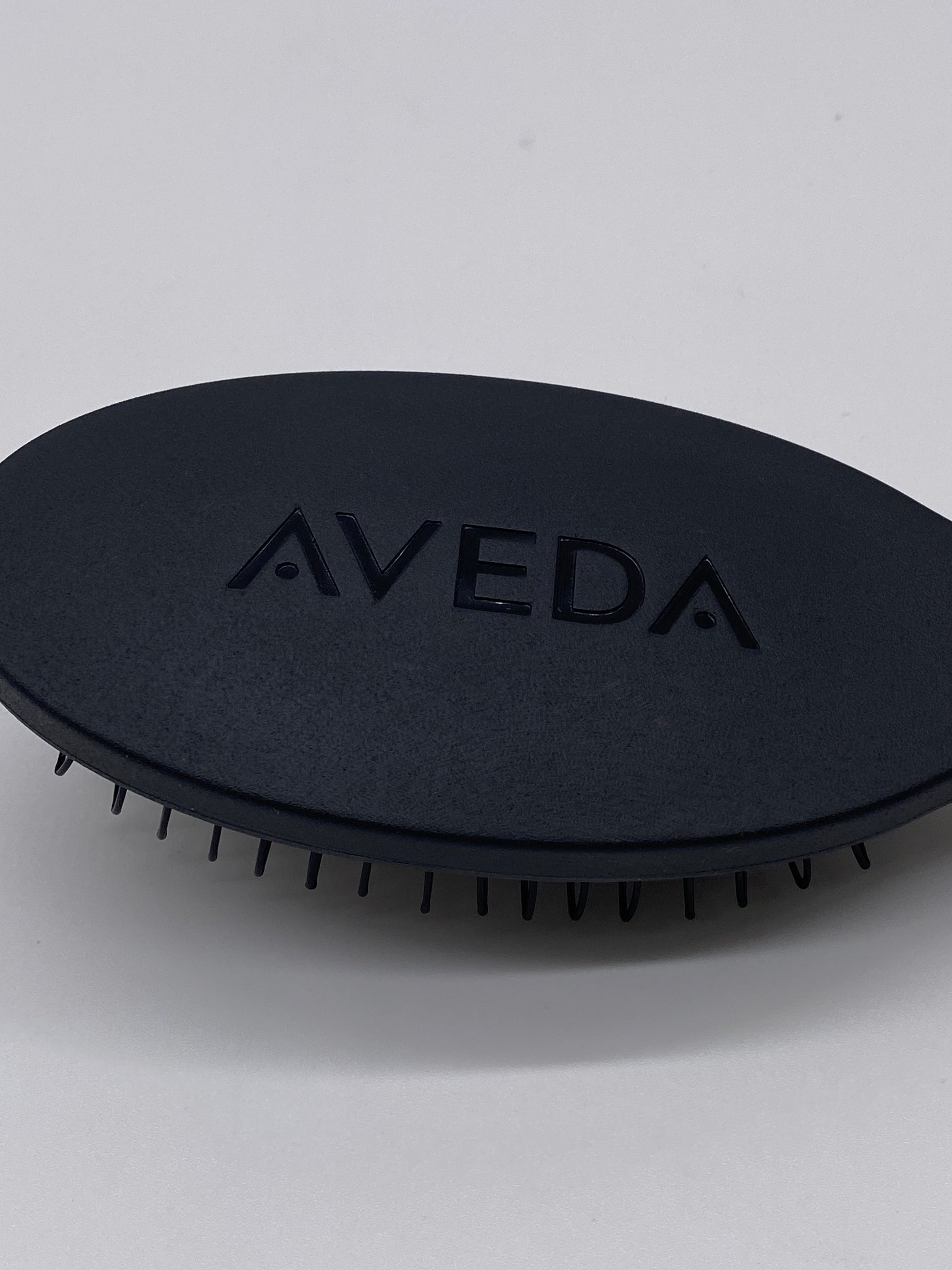 View of Aveda Pramasana Scalp Brush's ergonomic shape